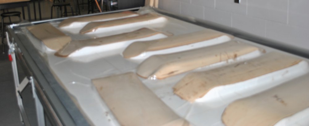 Wall hung frame press vacuum laminating multiple skateboards